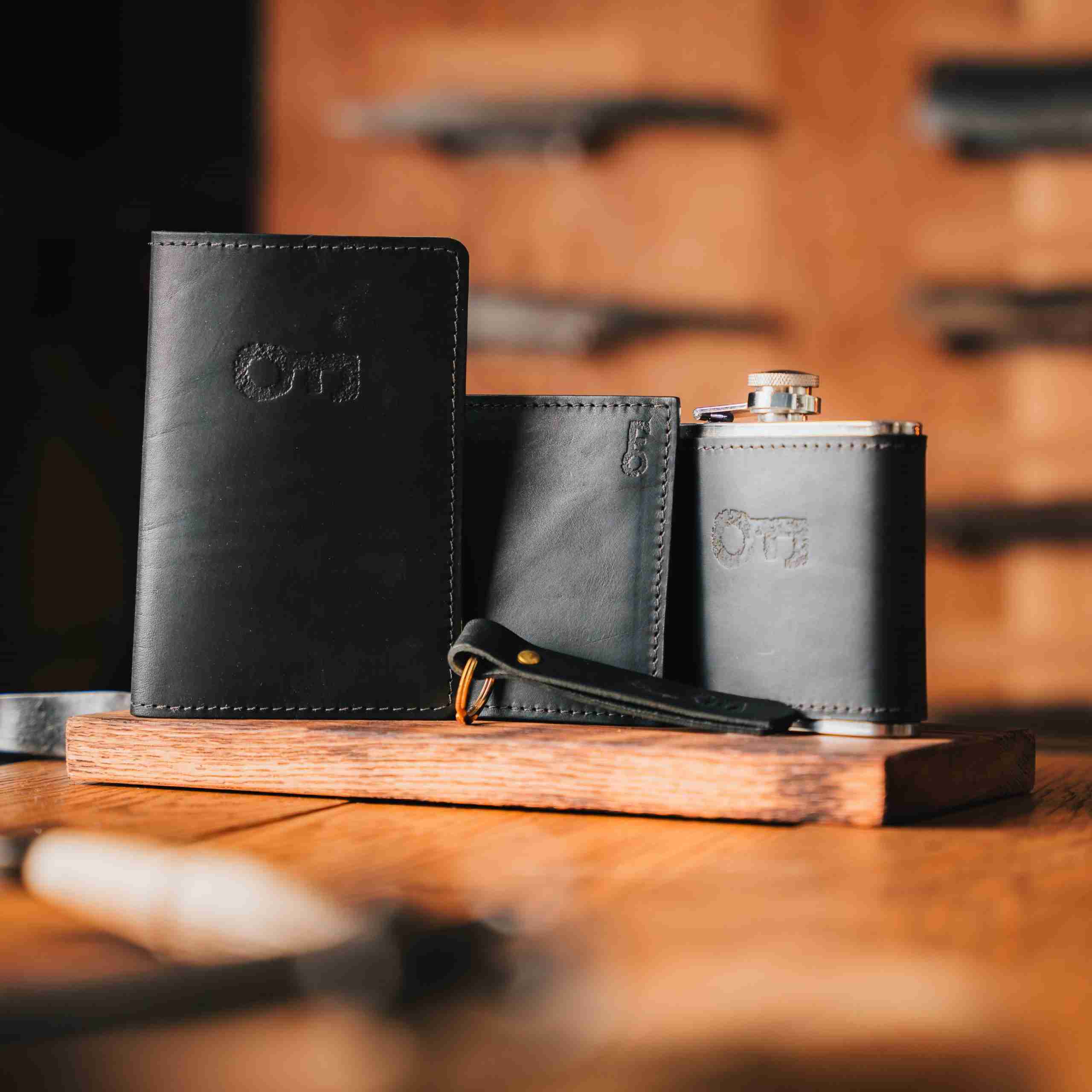 Black leather wallet, passport holder, hip flask and keyring